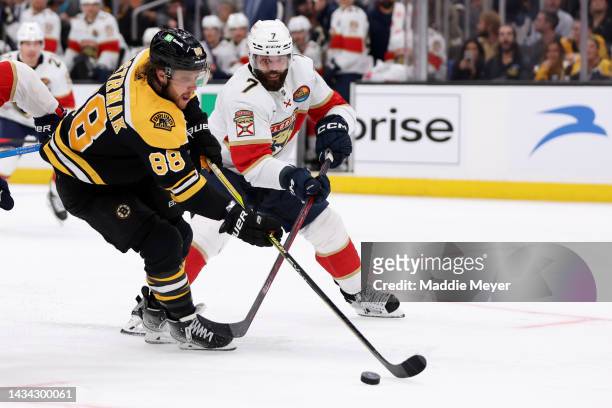 Radko Gudas of the Florida Panthers defends David Pastrnak of the Boston Bruins during the third period at TD Garden on October 17, 2022 in Boston,...