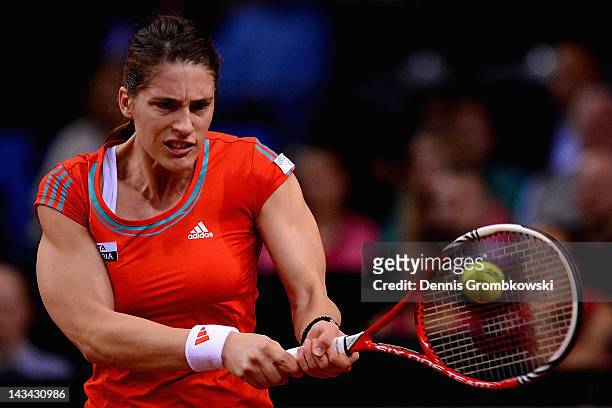 Andrea Petkovic of Germany plays a backhand in her match against Victoria Azarenka of Belarus during day four of the WTA Porsche Tennis Grand Prix at...