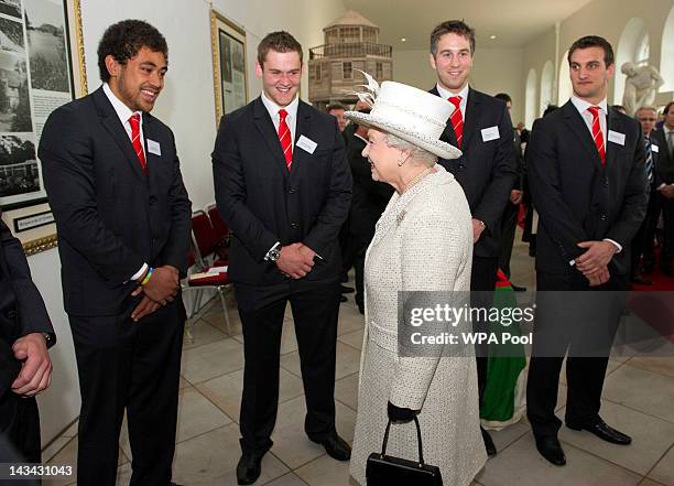 Queen Elizabeth II meets Welsh rugby players Toby Faletau, Dan Lydiate, Ryan Jones and captain Sam Warburton during a visit to Margam Country Park on...