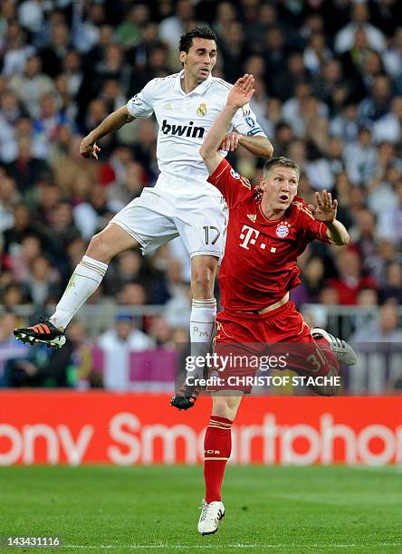 Bayern Munich's midfielder Bastian Schweinsteiger and Madrid's defender Alvaro Arbeloa jump for the ball during the UEFA Champions League semi final...