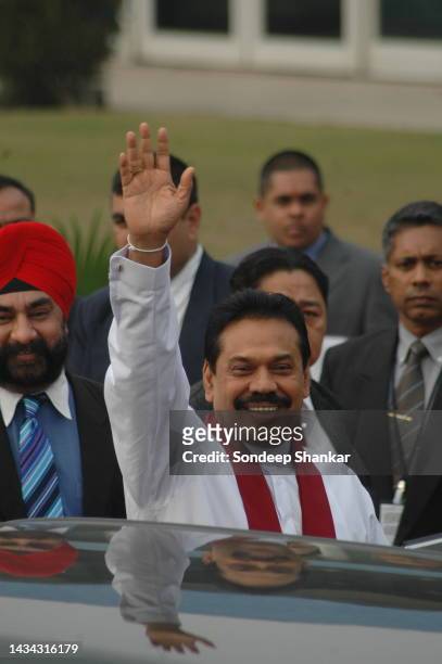 Sri Lanka President Mahinda Rajapaksa waves to the media on arrival at New Delhi Airport.