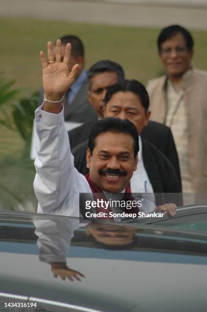 Sri Lanka President Mahinda Rajapaksa waves to the media on arrival at New Delhi Airport.