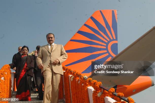 India's Minister for Civil Aviation Prafulla Patel breaks a Coconut on auspicious arrival of a newly acquired Airbus A-319 pained with a new logo of...