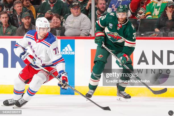 Alex Goligoski of the Minnesota Wild and Filip Chytil of the New York Rangers skate to the puck during the game at the Xcel Energy Center on October...