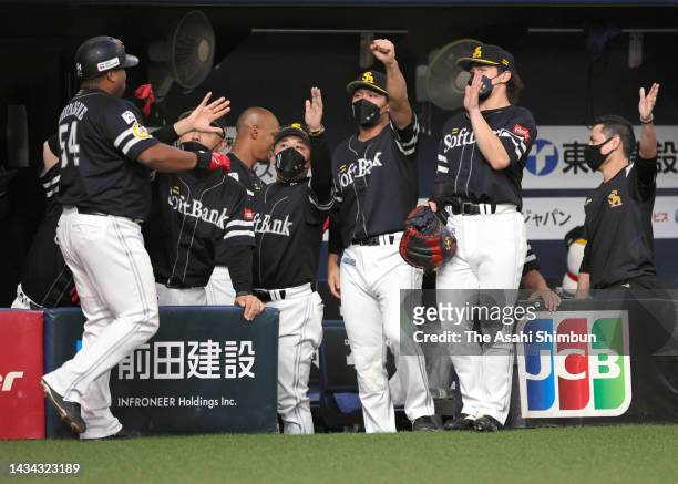 Alfredo Despaigne of the Alfredo Despaigne is congratulated by teammates after hitting a two run home run in the 7th inning against Orix Buffaloes...
