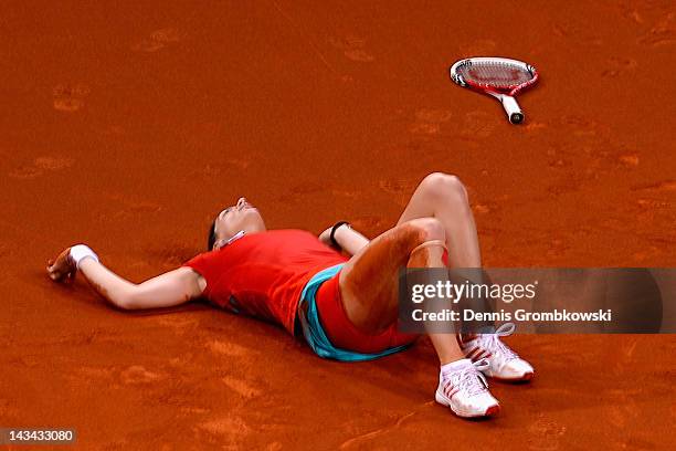 Andrea Petkovic of Germany lies on the court after suffering an injury in her match against Victoria Azarenka of Belarus during day four of the WTA...