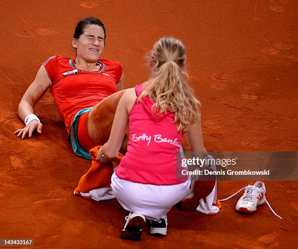 Andrea Petkovic of Germany lies on the court after suffering an injury in her match against Victoria Azarenka of Belarus during day four of the WTA...