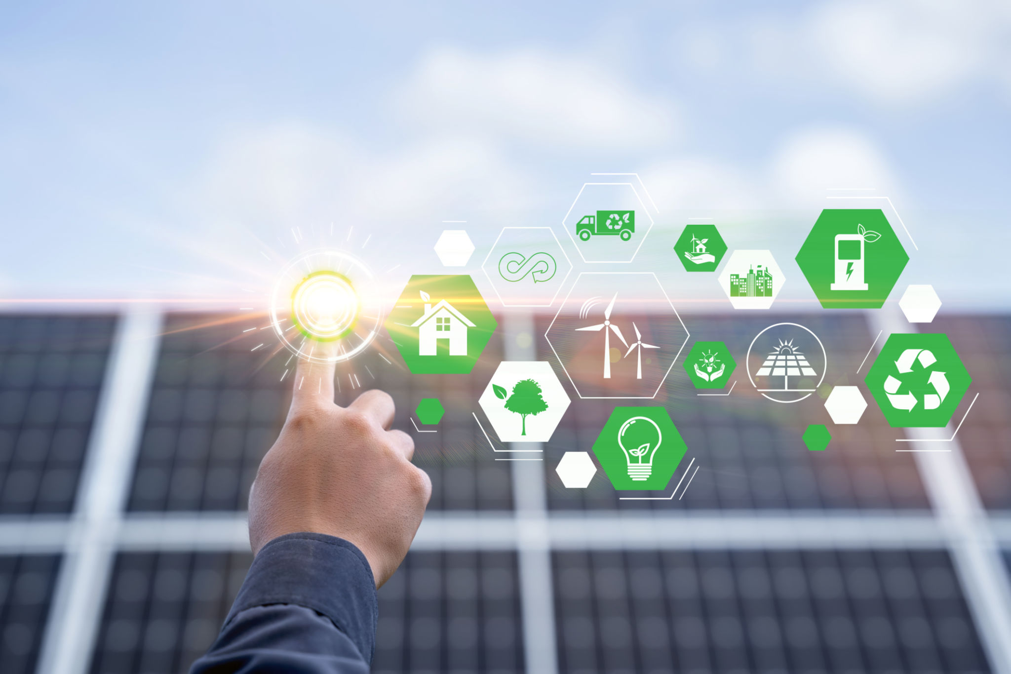 Hand with an icon of energy in front show symbols of various energies with a solar cell in the background, Concepts of clean energy source for renewable. power from the environment to save the world Hand with an icon of energy in front show symbols of various energies with a solar cell in the background, Concepts of clean energy source for renewable. power from the environment to save the world