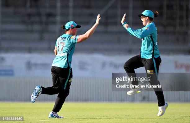 Grace Harris of the Heat celebrates taking the catch to claim the wicket of Hayley Matthews of the Renegades during the Women's Big Bash League match...