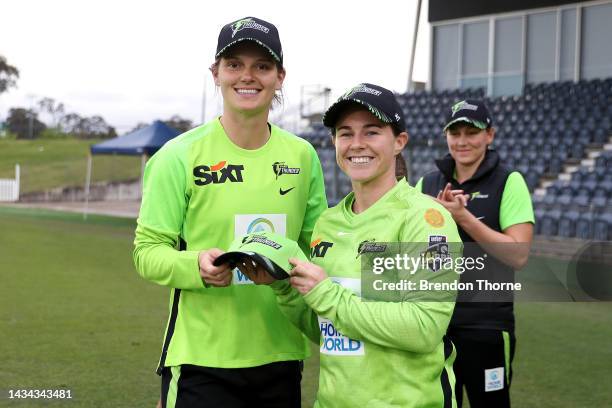 Tammy Beaumont of the Thunder presents a Thunder cap to debutante Amy Jones of the Thunder of the Thunder prior to the Women's Big Bash League match...