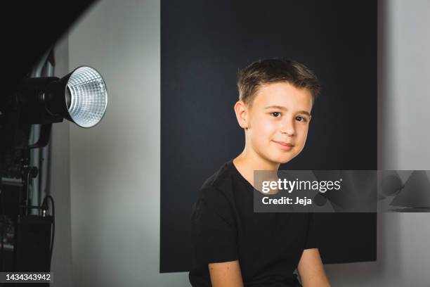 boy in a photo shoot, looking at camera and smiling - preteen model stock pictures, royalty-free photos & images