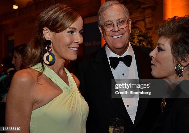 David Koch, executive vice president of chemical technology for Koch Industries Inc., center and wife Julia Flesher, left, speak with a guest during...