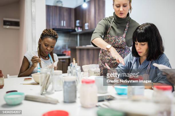 group of people learning ceramic art - art class stock pictures, royalty-free photos & images
