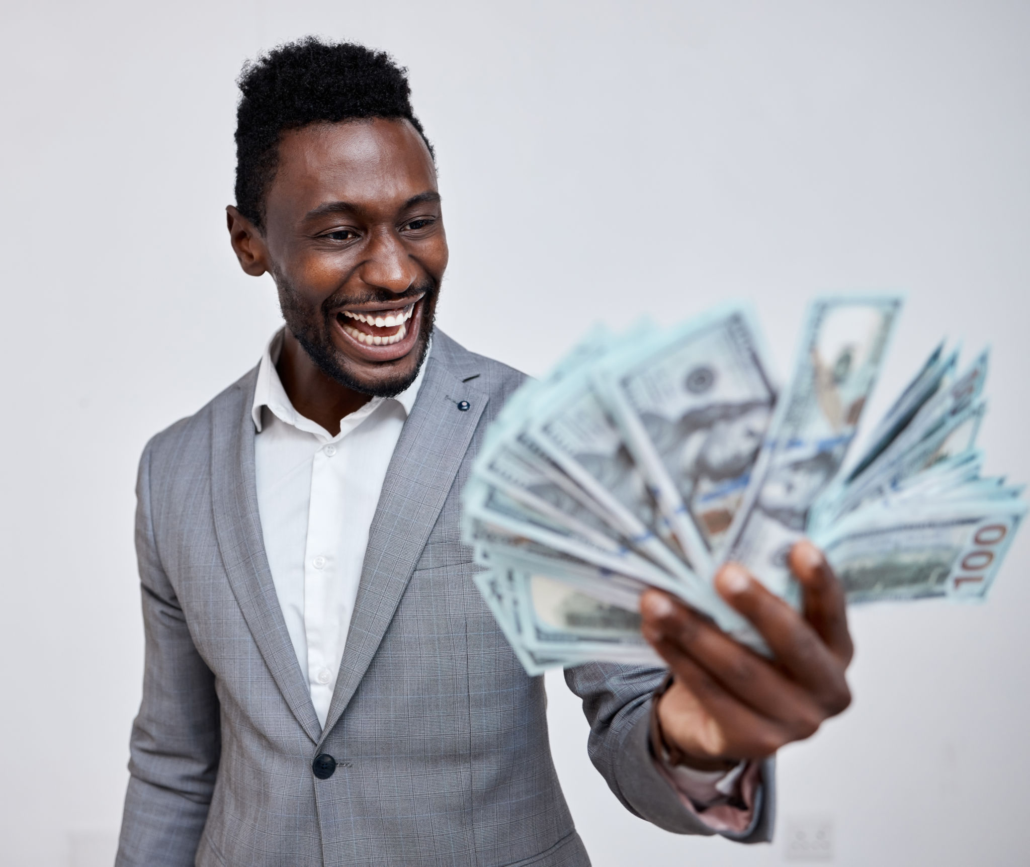Happy black man with dollars, money or winner isolated on a grey mockup background. Finance, wealth and excited rich African person with a stack of bills, lotto or financial investment business deal Happy black man with dollars, money or winner isolated on a grey mockup background. Finance, wealth and excited rich African person with a stack of bills, lotto or financial investment business deal