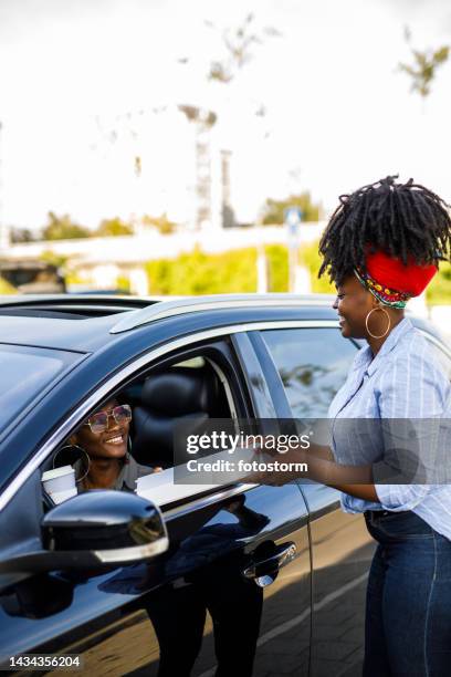 customer getting her pizza and a cup of coffee at the drive through - drive through stock pictures, royalty-free photos & images