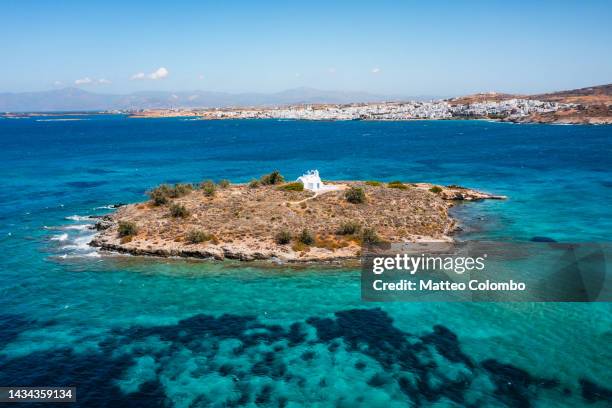 small church on an island and town of naoussa, paros - cyclades islands stockfoto's en -beelden