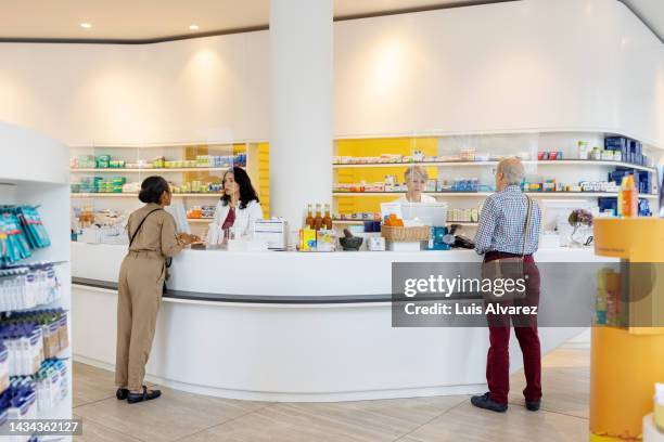customers buying medicines from a medical store. - pharmacy stock pictures, royalty-free photos & images