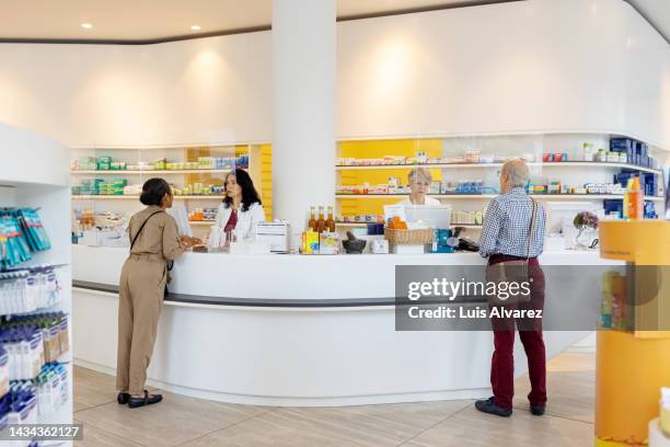 customers buying medicines from a medical store. - pharmacy imagens e fotografias de stock