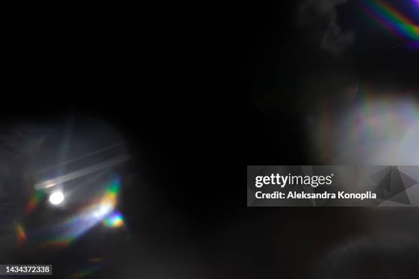 colourful rainbow light leaks texture on black background - beleuchtungstechnik stock-fotos und bilder
