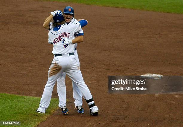 Kirk Nieuwenhuis of the New York Mets celebrates with teammate Scott Hairston after hitting a walk-off single in the ninth-inning against the Miami...