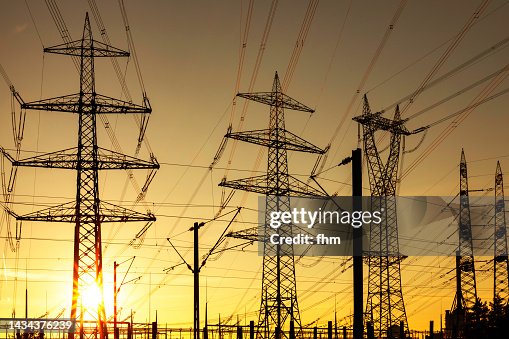 Large electricity pylons at sunset Large electricity pylons at sunset