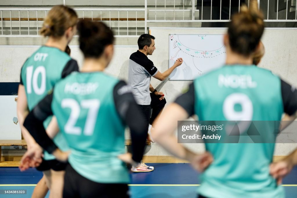 Coaches explaining the game plan and strategy on board
