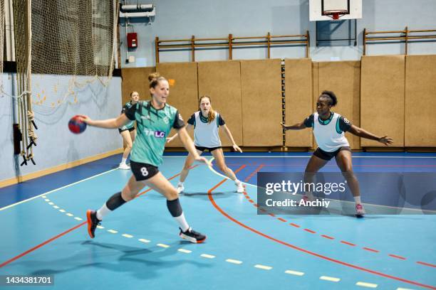 women handball players in action - handbal stockfoto's en -beelden