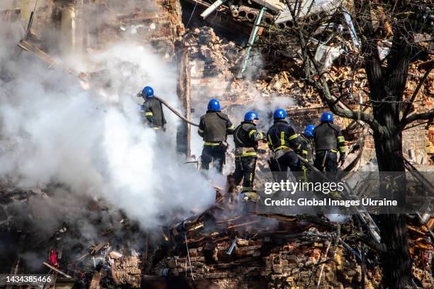 Rescuers sort through the rubble of a residential building hit by Russian kamikaze drones as explosions rock Ukraine’s capital during a drone attack...