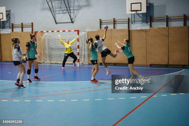 group of women handball players in action. - handbal stockfoto's en -beelden