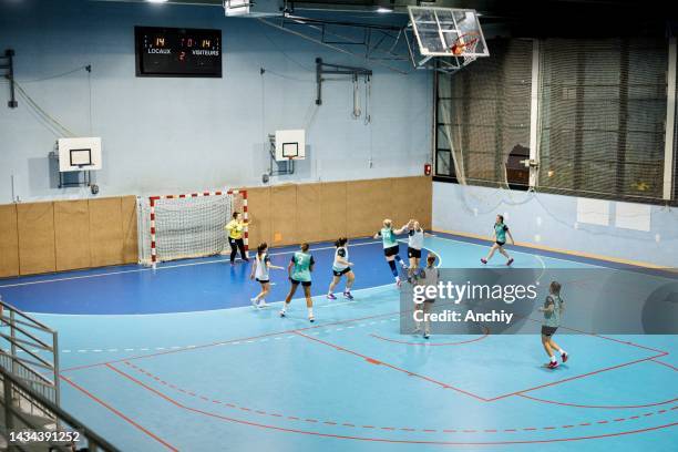 group of women handball players in action. - handbal stockfoto's en -beelden