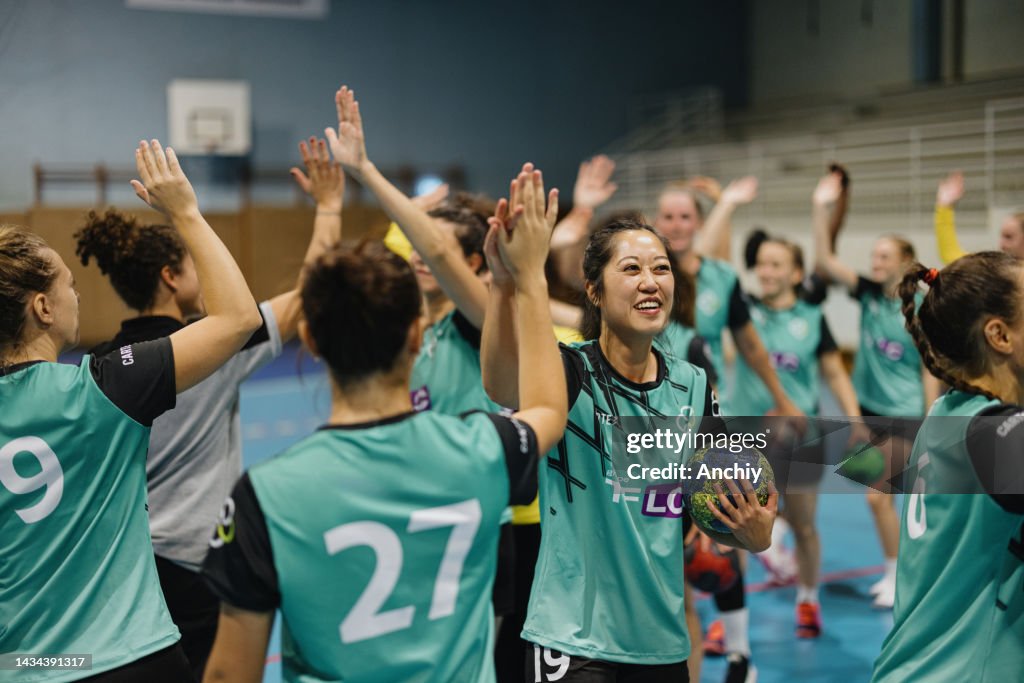 High five between women's handball teammates