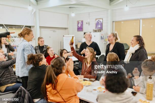 teammates toasting during an apero after training - apero stock pictures, royalty-free photos & images
