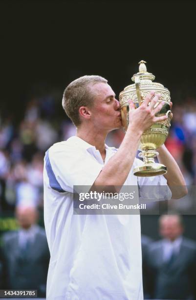 Lleyton Hewitt from Australia kisses the Gentlemen's Singles Championship Trophy after defeating David Nalbandian of Argentina during their Men's...