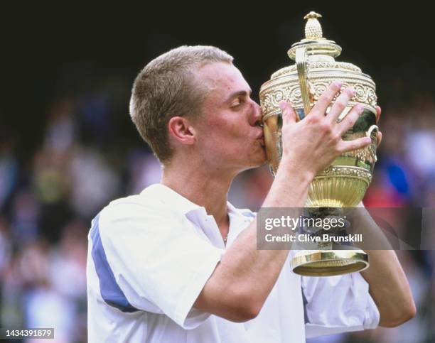 Lleyton Hewitt from Australia kisses the Gentlemen's Singles Championship Trophy after defeating David Nalbandian of Argentina during their Men's...
