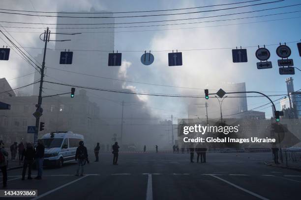 Press and police members stand on the crossroad at an area which was attacked by “kamikaze drones” on October 17, 2022 in Kyiv, Ukraine. After attack...