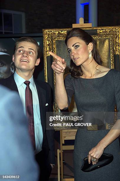 Catherine, Duchess of Cambridge , speaks with the son of Lord and Lady Rothermere during a visit of the new galleries of the Imperial War Museum in...