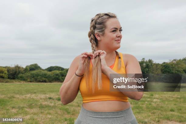 female runner tying hair - braids stock pictures, royalty-free photos & images