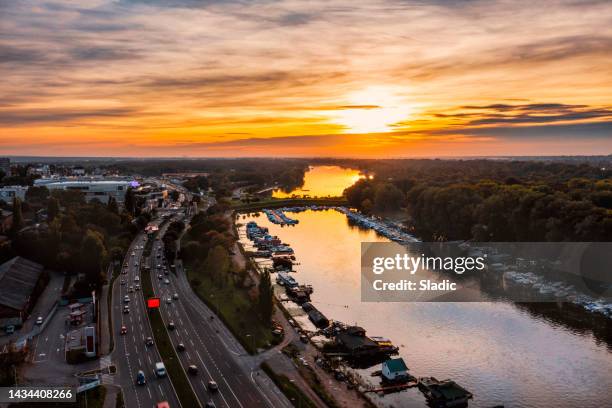dramatic sunset at the sky above the river and city - belgrade skyline imagens e fotografias de stock