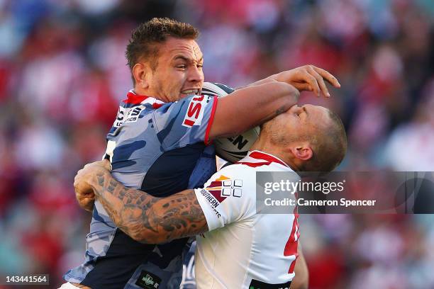 Jared Waerea-Hargreaves of the Roosters fends off Matt Cooper of the Dragons during the round eight NRL match between the St George Illawarra Dragons...