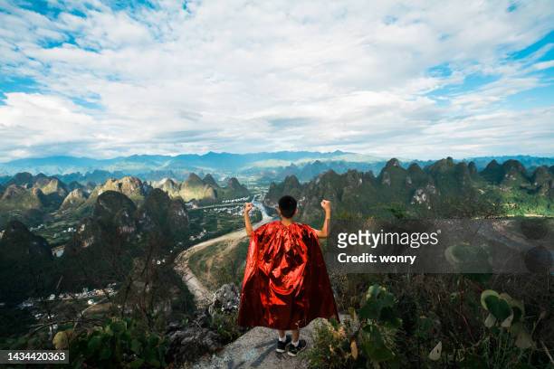 young superhero showing muscles at mountain peak - guilin stock pictures, royalty-free photos & images