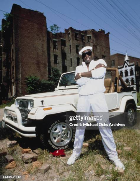 Koolu Rapper Rapper Kool Moe Dee posing in front of a white Jeep during a photo ...