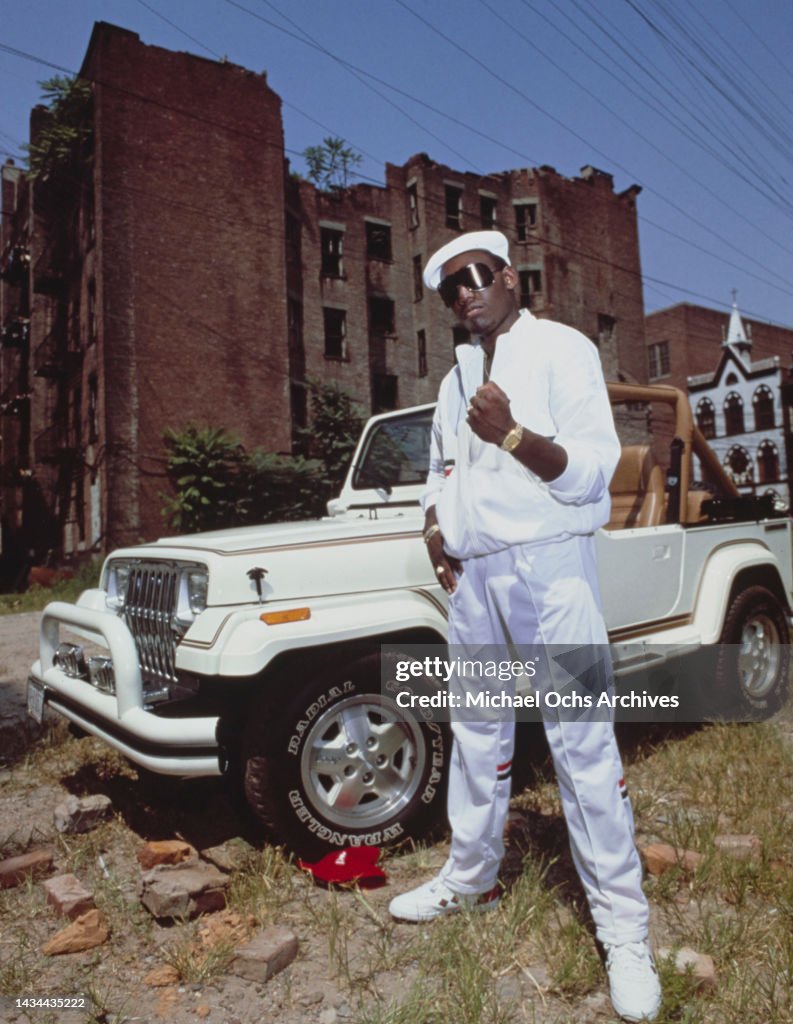 Koolu Rapper Rapper Kool Moe Dee posing in front of a white Jeep during a photo ...