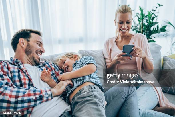 happy family at home. - white sofa stock pictures, royalty-free photos & images