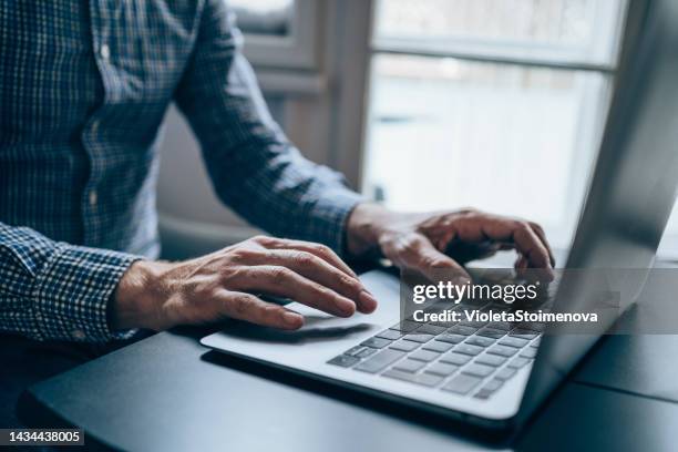 successful businessman in modern office working on laptop. - facebook computer stock pictures, royalty-free photos & images