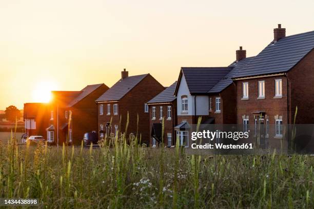 residential detached houses in town at sunset - detached house stock pictures, royalty-free photos & images