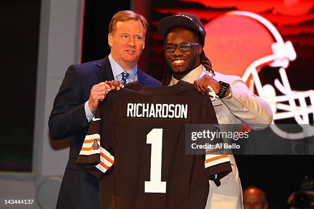 Trent Richardson from Alabama holds up a jersey as he stands on stage with NFL Commissioner Roger Goodell after he was selected overall by the...