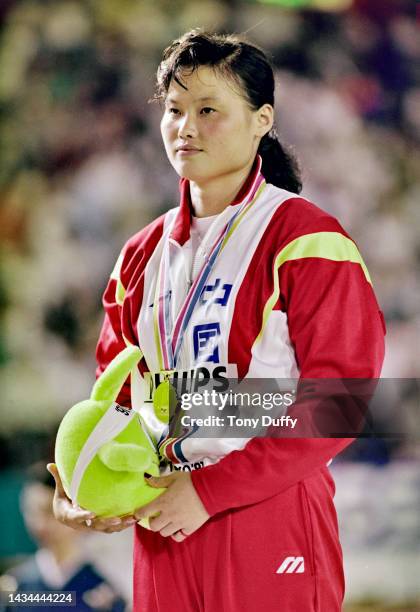 Xu Demei from China stands on the podium with her gold medal after winning the Women's Javelin competition during the 3rd International Association...