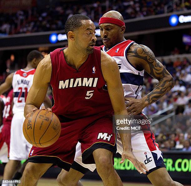 Miami Heat power forward Juwan Howard is defended by Washington Wizards power forward James Singleton during the first half of their game played at...