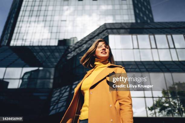 beautiful woman on the background of high business building. - high tech beauty stockfoto's en -beelden