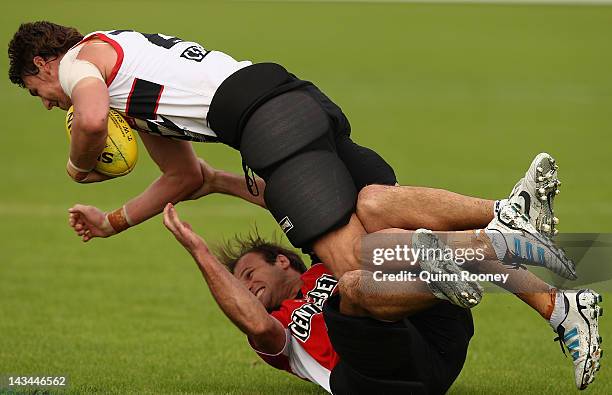 Justin Koschitzke of the Saints is tackled by assistant coach Aaron Hamill during a St Kilda Saints AFL training session at Linen House Oval on April...